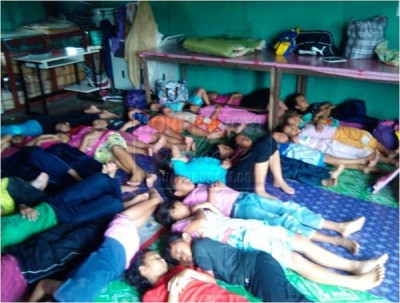 Sleeping facilities in a Sarawak rural boarding school with leaking roof above.